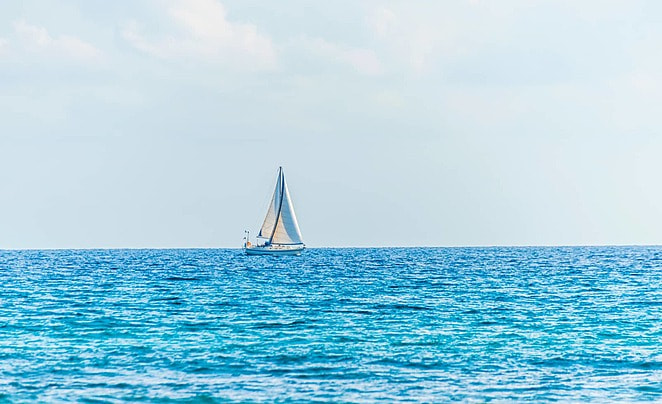 pngtree-a-sailboat-gliding-across-the-open-sea-embarking-on-a-peaceful-cruise-photo-photo-image_30447040.jpg